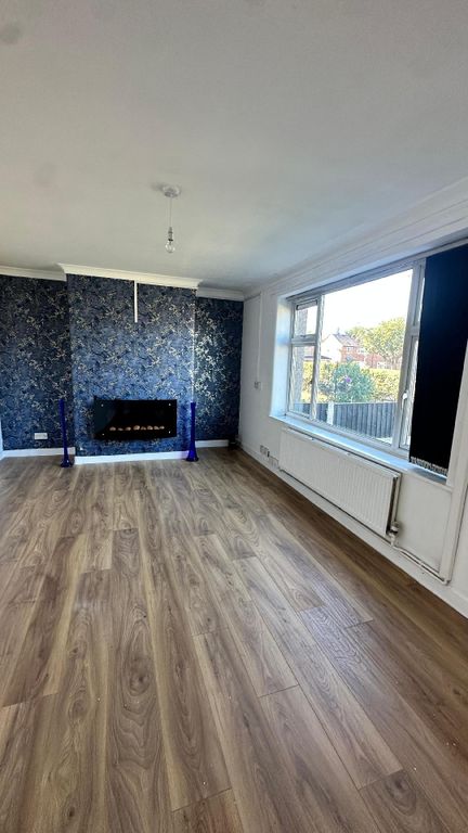 Property photo 1 of 7 Bright And Spacious Living Room Featuring A Large ...