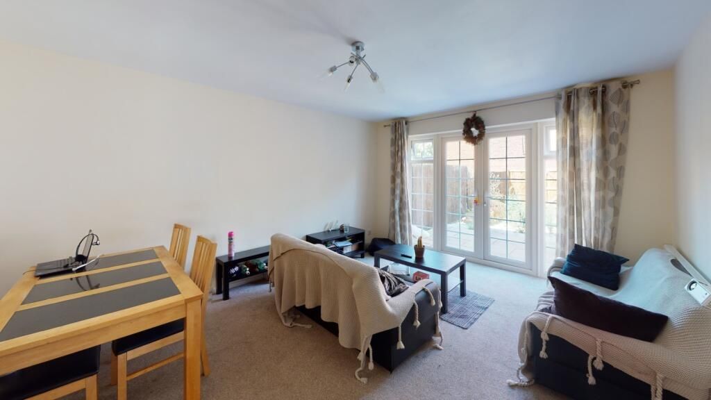 Property photo 3 of 10 Bright And Inviting Living Room Featuring A Comfor...