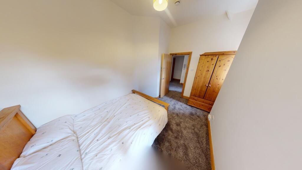Property photo 2 of 9 A Cozy Single Bedroom Featuring A Comfortable Bed,...