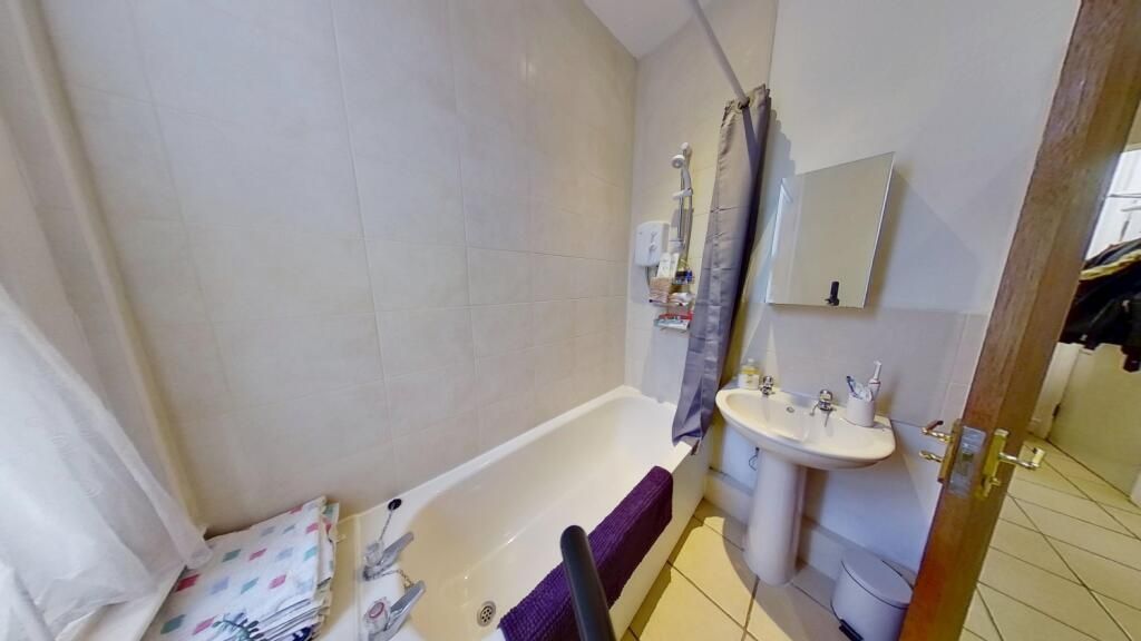Property photo 2 of 4 Bright Bathroom Suite Featuring A Clean White Bath...