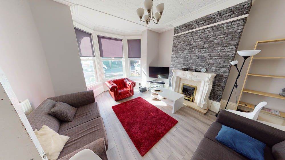 Property photo 2 of 7 A Spacious, Well-Lit Living Room Featuring Contemp...