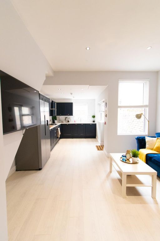 Property photo 1 of 11 A Spacious And Modern Living Room With Ample Natur...