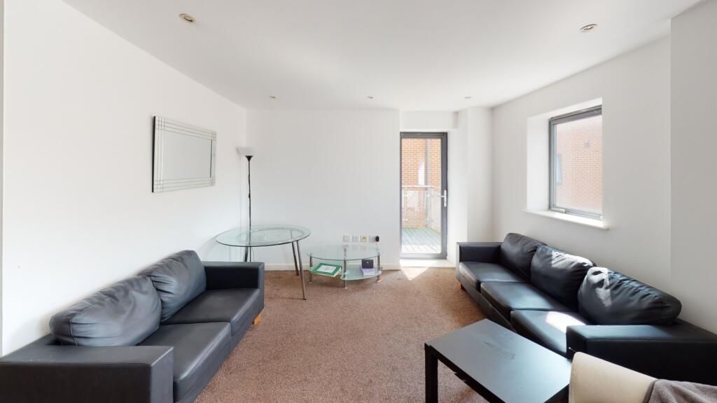 Property photo 2 of 5 A Bright And Inviting Living Room Featuring Two Co...