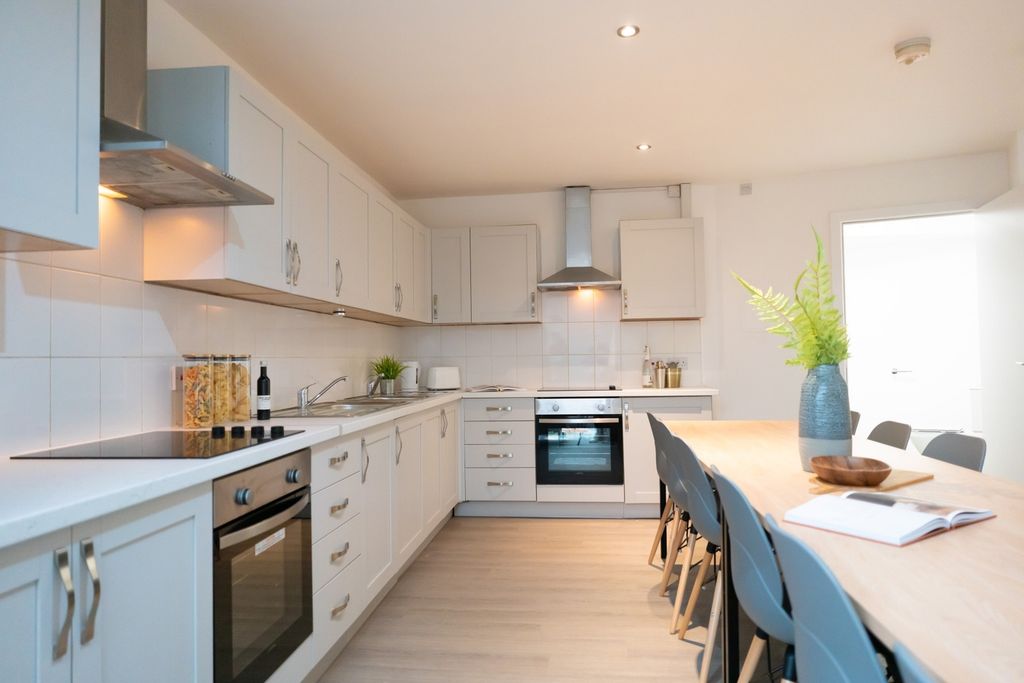 Property photo 3 of 4 A Bright And Spacious Kitchen Featuring Modern App...