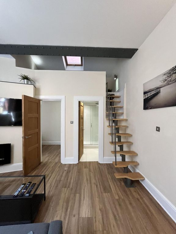 Property photo 3 of 16 A Modern Living Room Featuring A Sleek Floating St...