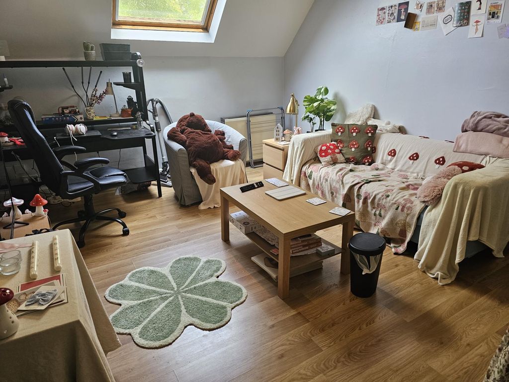 Property photo 1 of 7 A Cozy And Inviting Living Room Featuring Comforta...