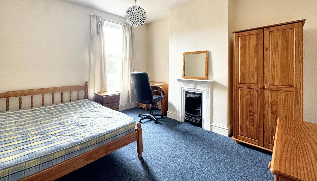 Property photo 3 of 12 A Bright Double Bedroom Featuring A Wooden Bed Fra...