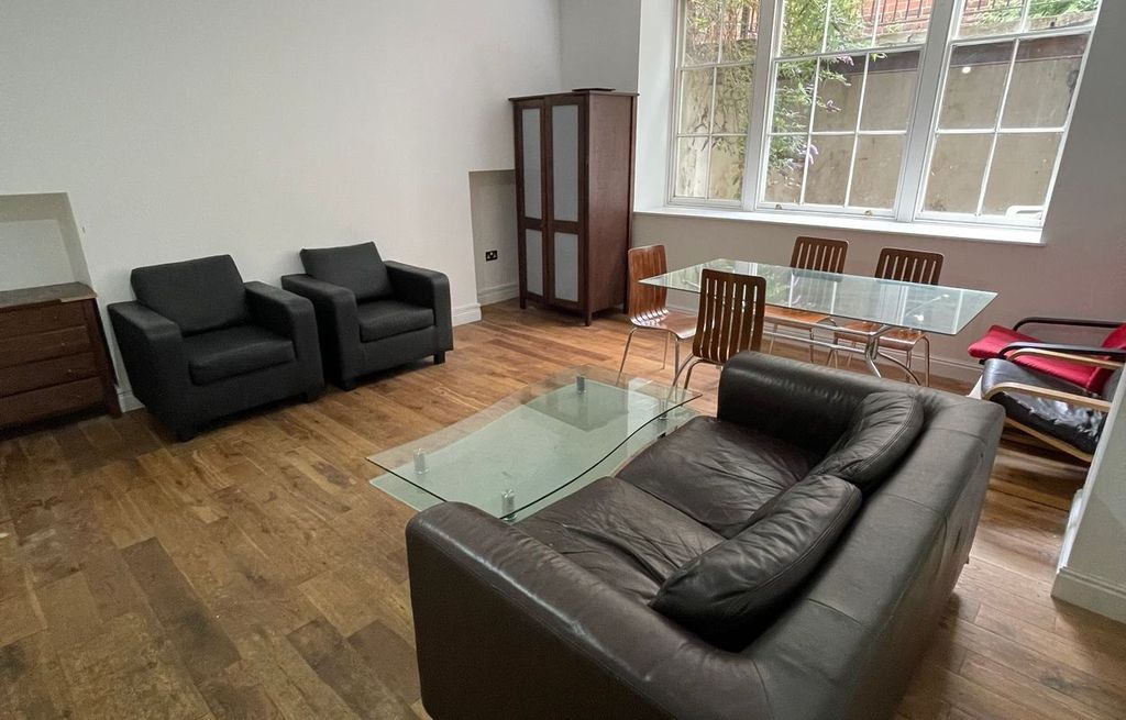 Property photo 2 of 7 A Cozy Living Room Featuring A Comfortable Leather...