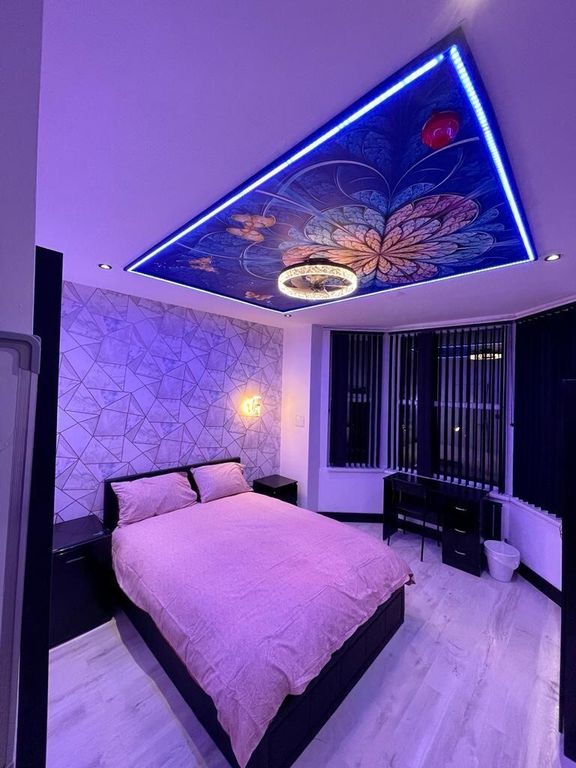 Property photo 2 of 12 A Stylish Master Bedroom Featuring A Comfortable d...