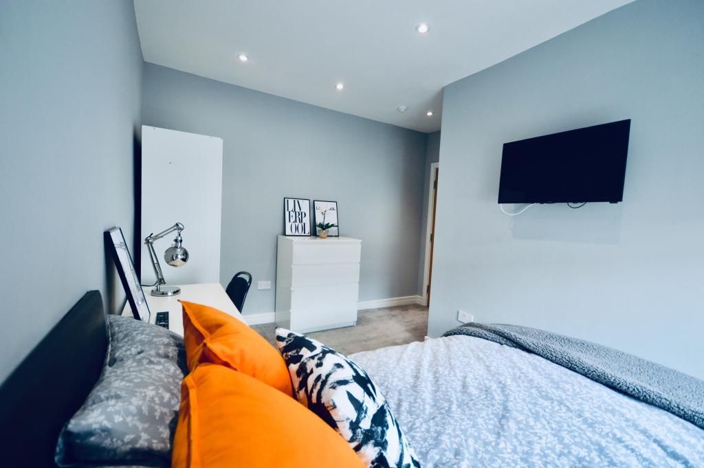 Property photo 2 of 13 A Spacious And Well-Lit Bedroom Featuring A Large ...