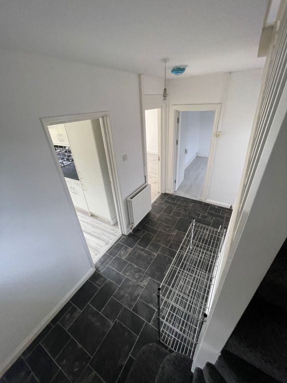 Property photo 3 of 12 A Clean And Tidy Hallway Featuring Dark Tiled Floo...