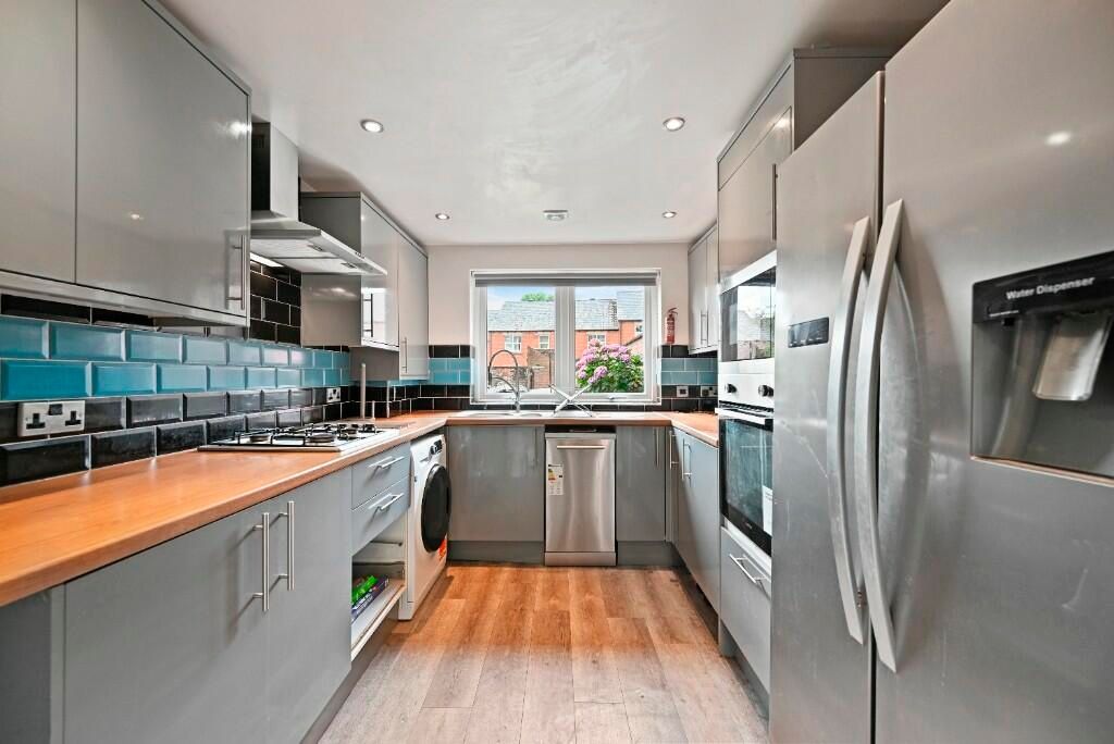 Property photo 3 of 13 A Modern And Well-Equipped Kitchen Featuring Sleek...