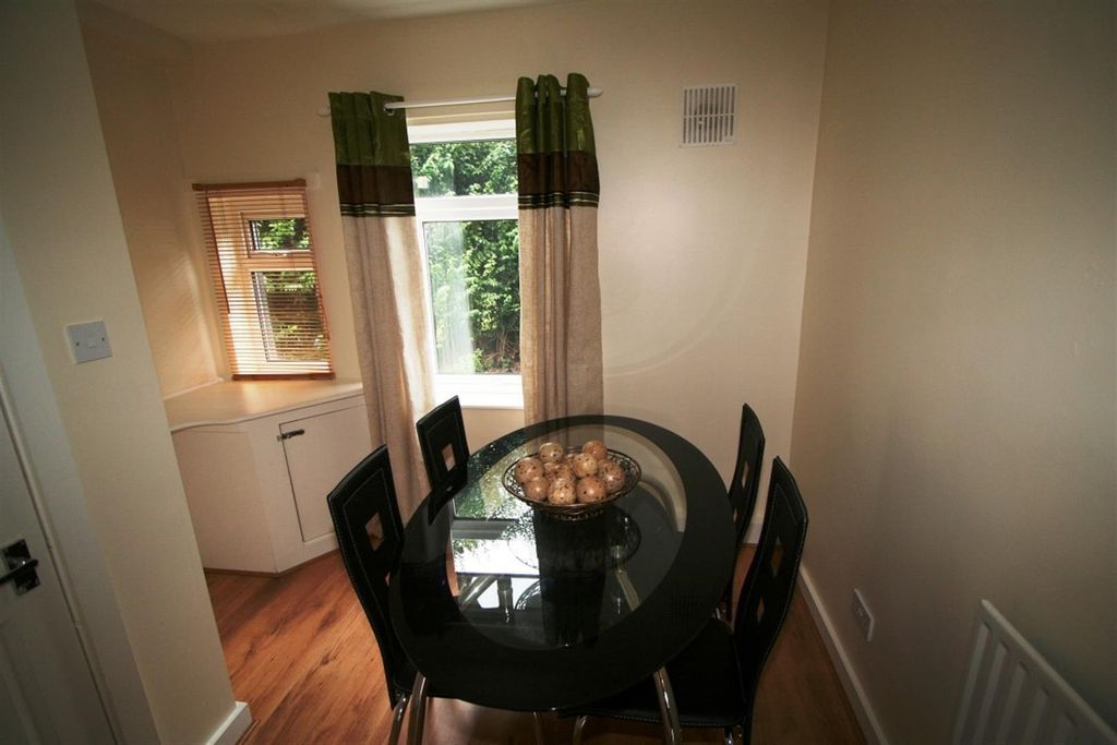 Property photo 2 of 5 Elegant Dining Area With Sleek Glass Table...