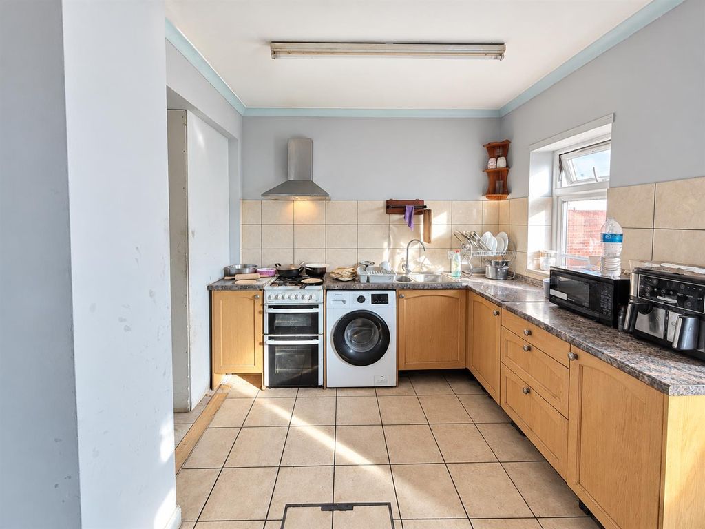 Property photo 3 of 6 Modest Sunlit Kitchen Interior.Png