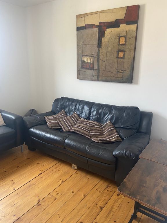 Property photo 3 of 14 A Cozy Living Room Featuring A Comfortable Leather...