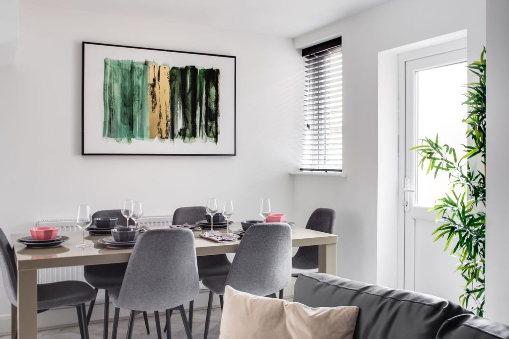 Property photo 3 of 7 A Bright And Modern Living Room Featuring A Minima...