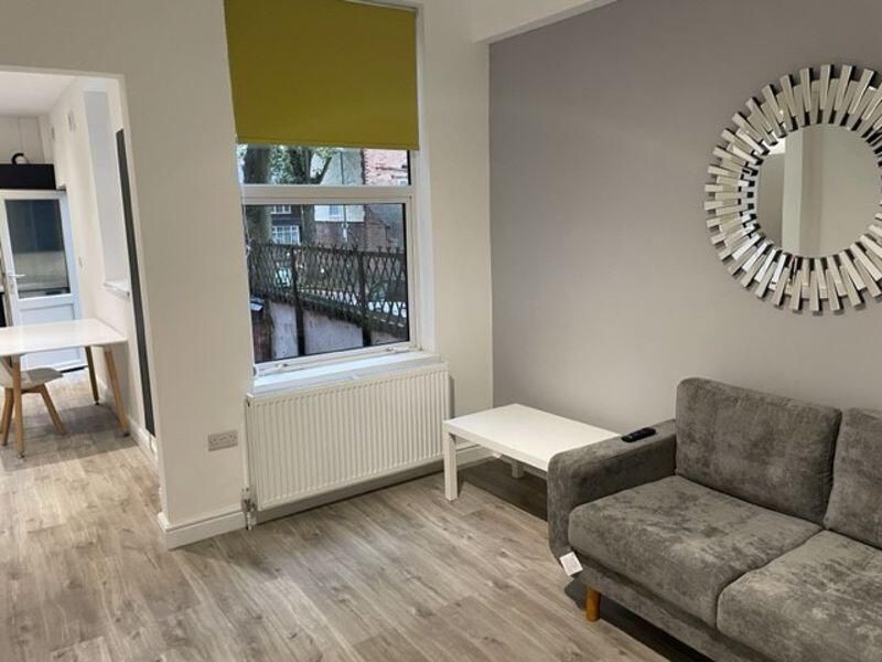 Property photo 1 of 11 A Modern And Inviting Living Room Featuring A Comf...