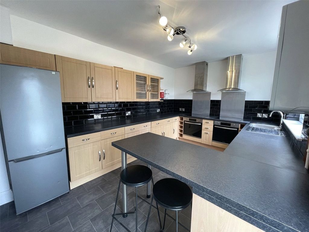 Property photo 2 of 7 A Spacious And Modern Kitchen Featuring Sleek Cabi...
