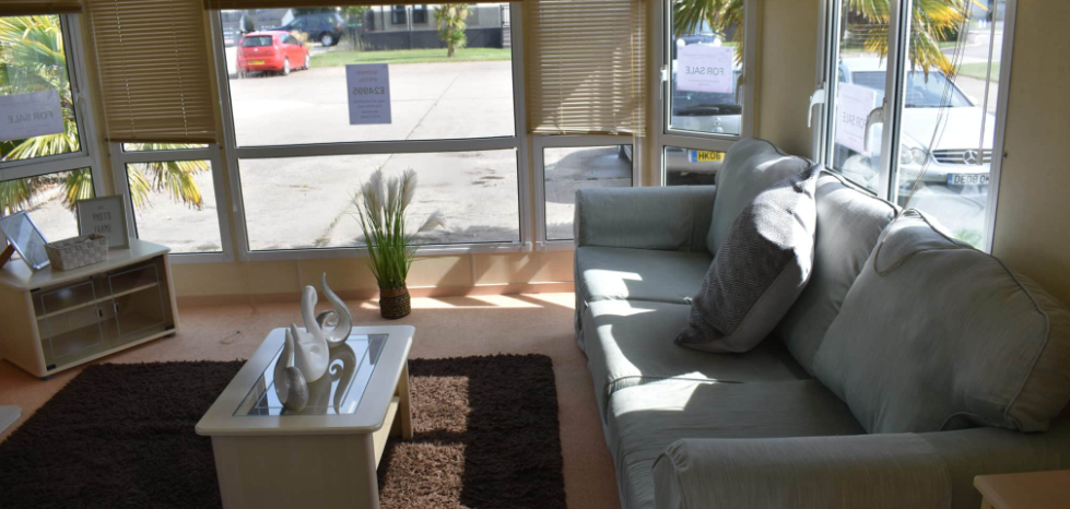 Property photo 3 of 9 Spacious Lounge Area With Large Front Windows, Light Blue Sofa, Coffee Table And Natural Light Throughout