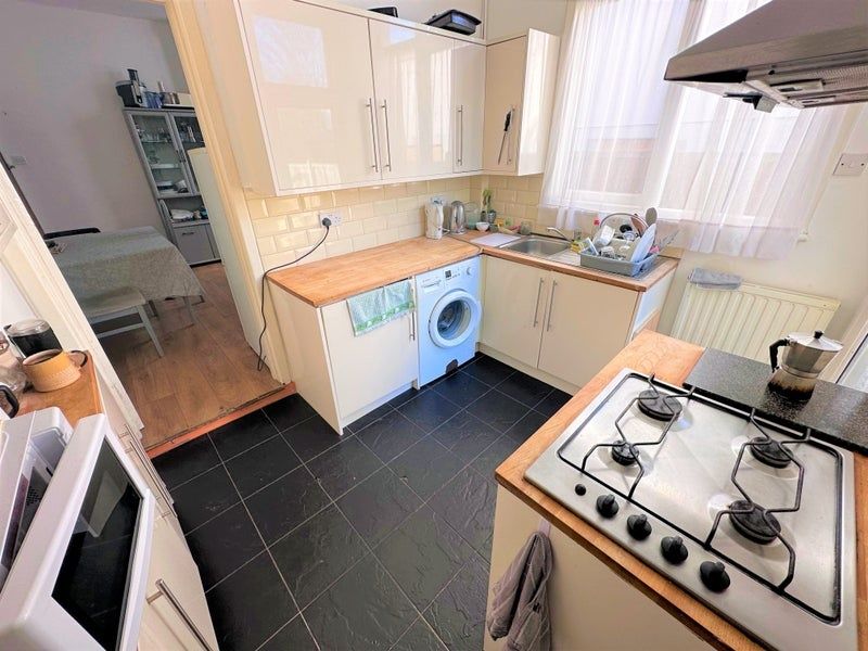 Property photo 3 of 7 Bright And Tidy Kitchen Featuring Modern Cream Cab...