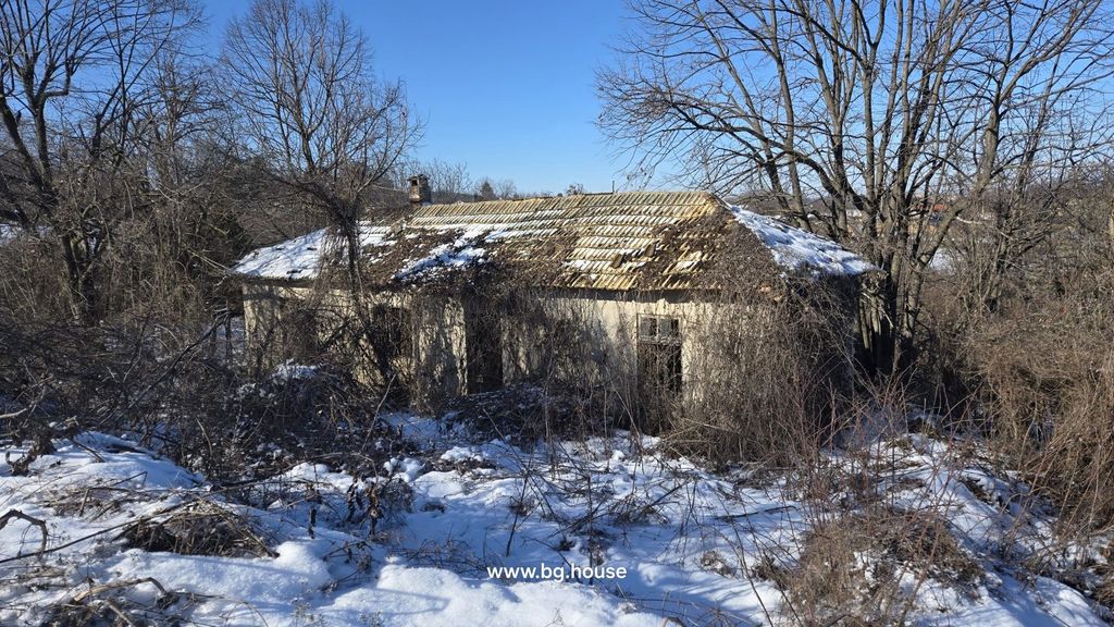 Property photo 1 of 20 An Old House With A Partially Damaged Roof And Snow On The Ground, Surrounded By Bare Trees In Winter.