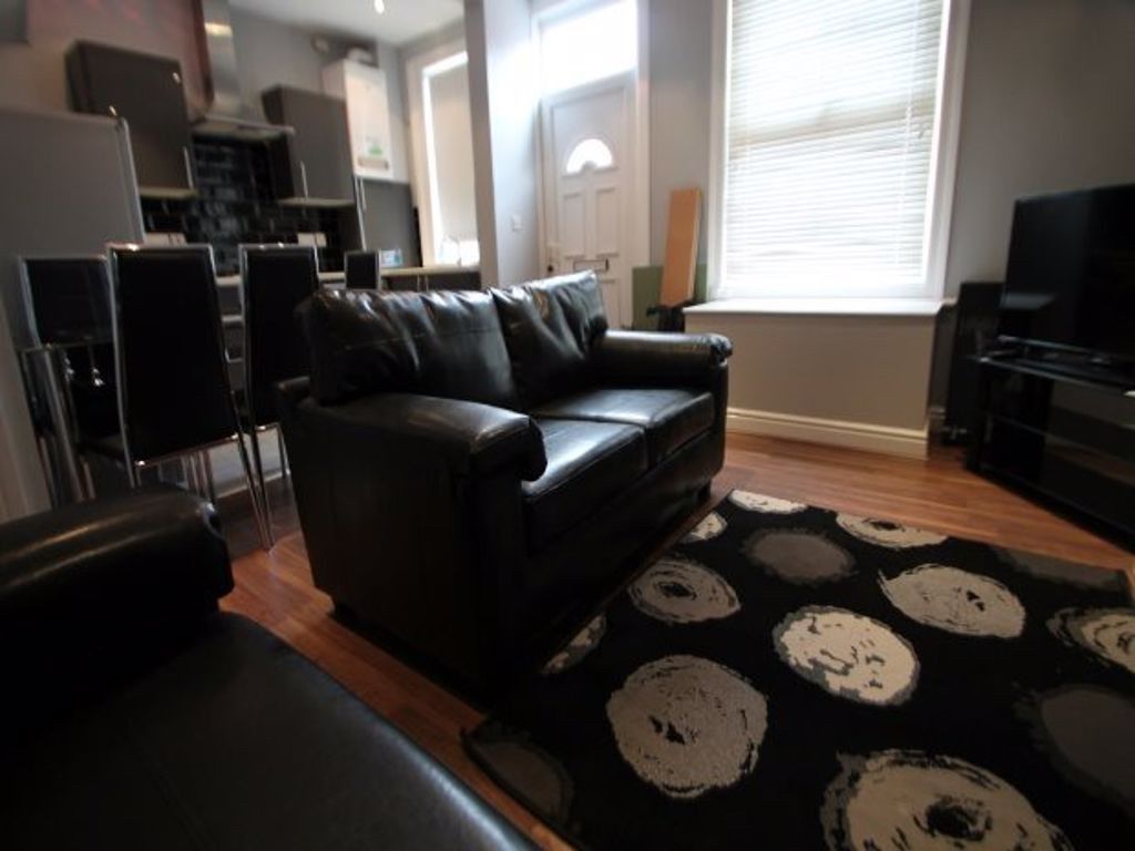 Property photo 3 of 29 A Cozy Living Room Featuring Comfortable Black Lea...