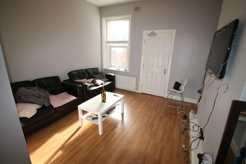 Property photo 2 of 8 Spacious And Inviting Living Room Featuring Comfor...
