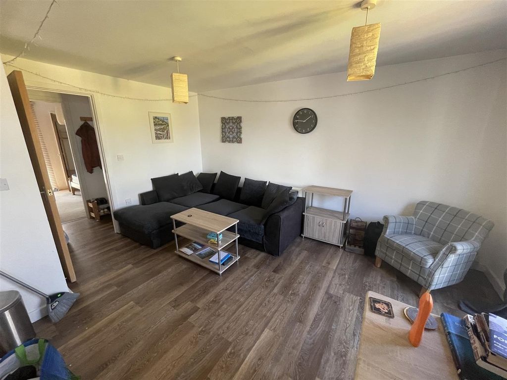 Property photo 3 of 9 Inviting Lounge With Large Sofa And Wood Floors...