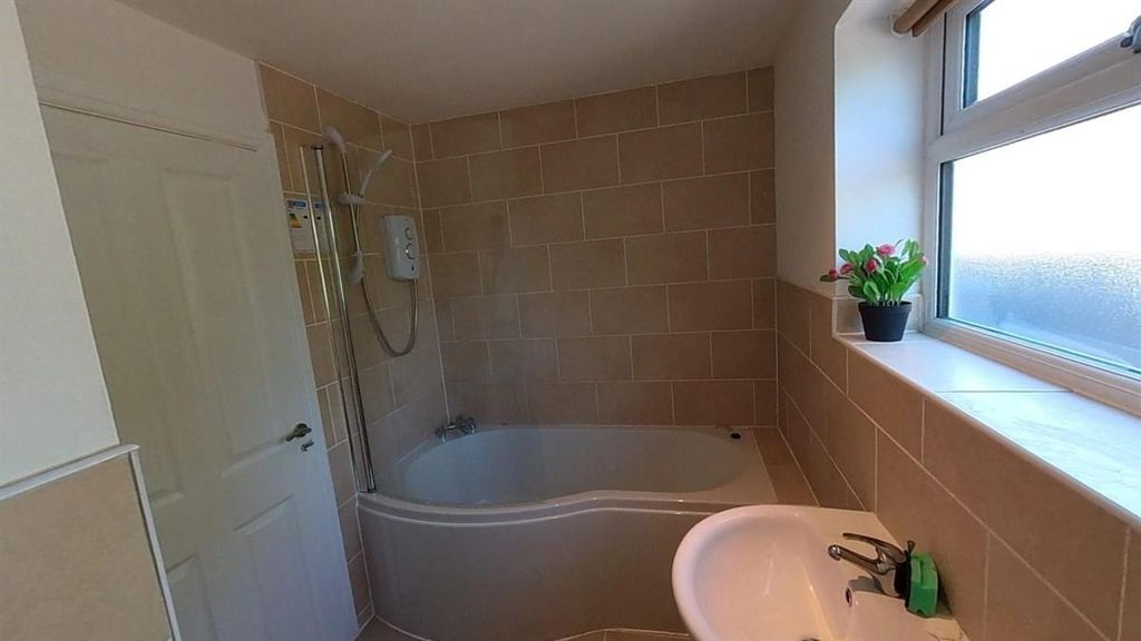 Property photo 2 of 8 Bright Bathroom Suite With A Modern Bathtub...
