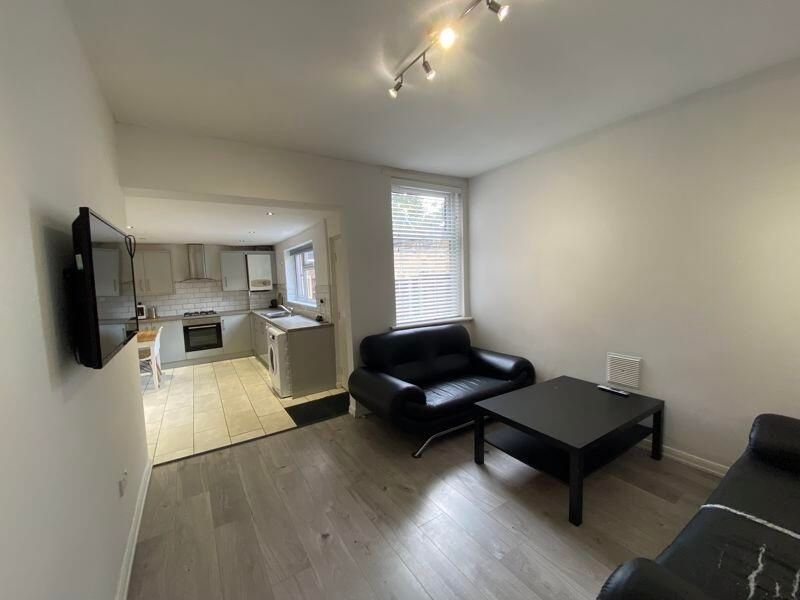 Property photo 1 of 12 A Modern, Well-Lit Living Room Featuring A Black S...