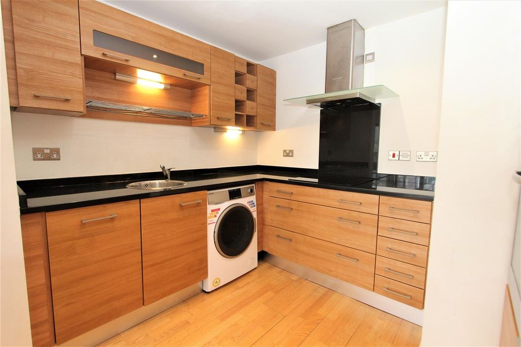 Property photo 3 of 13 Modern Fitted Kitchen With Sleek Black Counters...