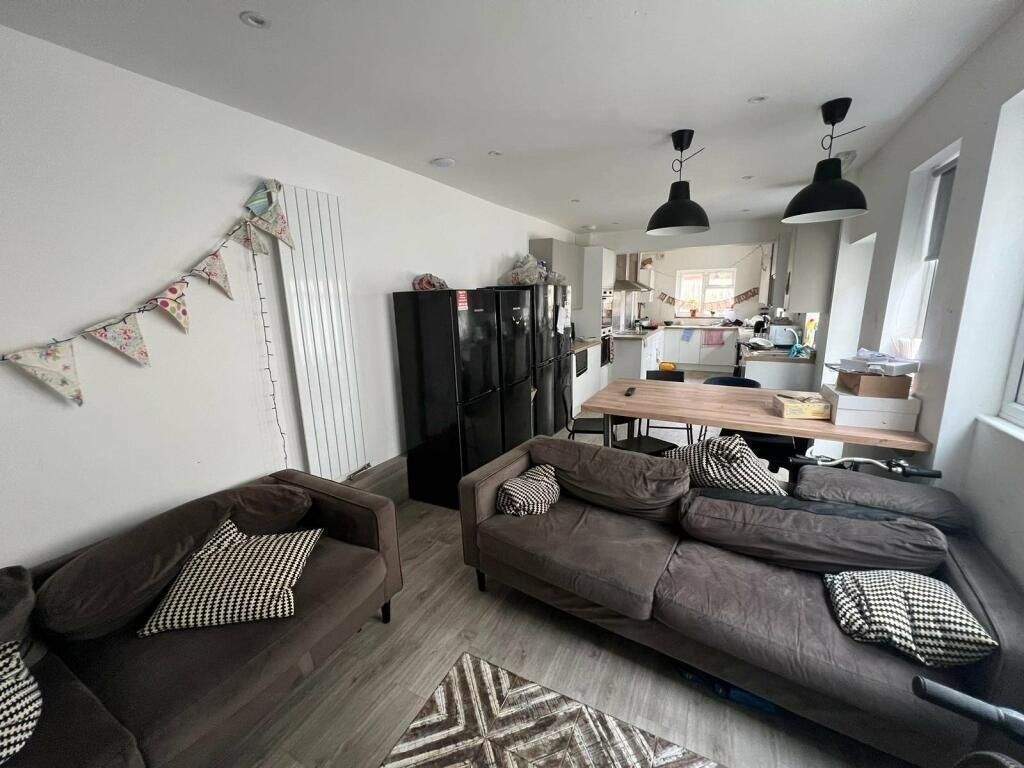 Property photo 3 of 15 A Spacious, Modern Living Room Featuring Comfortab...