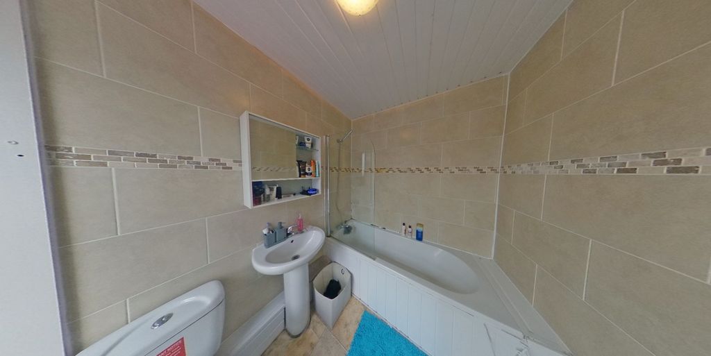 Property photo 3 of 8 Bright, Modern Bathroom With Tiled Walls, A Bathtu...