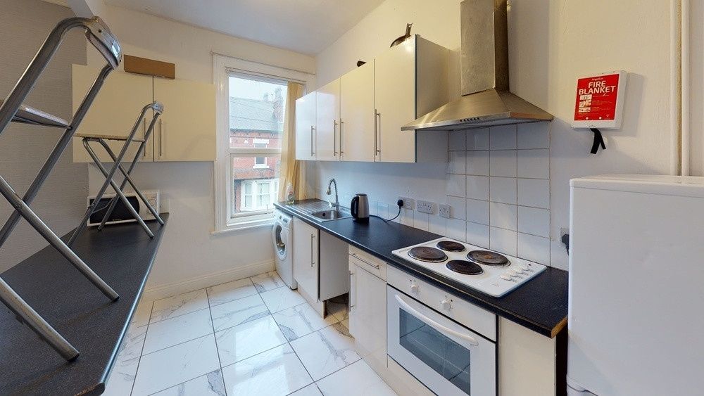 Property photo 2 of 4 Bright And Functional Kitchen Featuring Modern Whi...
