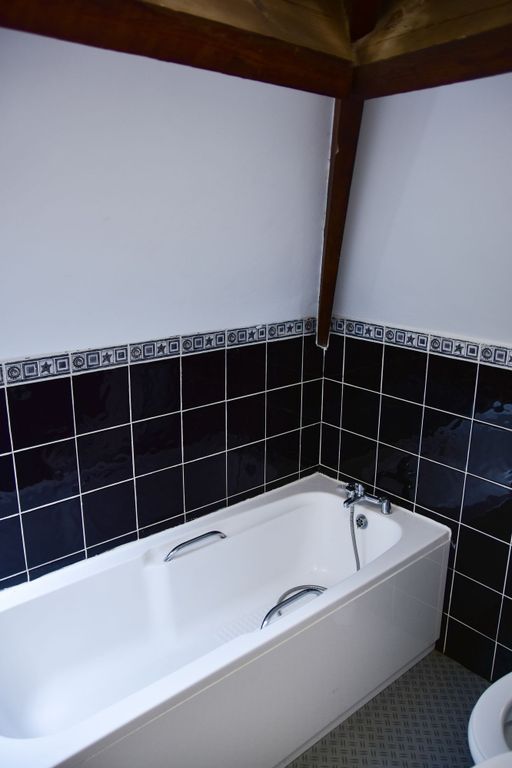 Property photo 2 of 9 Bright Bathroom Suite Featuring A Clean, White Bat...