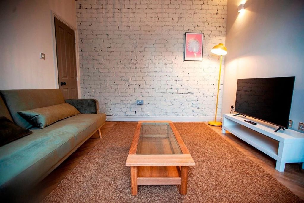 Property photo 2 of 9 Cozy Lounge With Sofa, TV And Coffee Table...