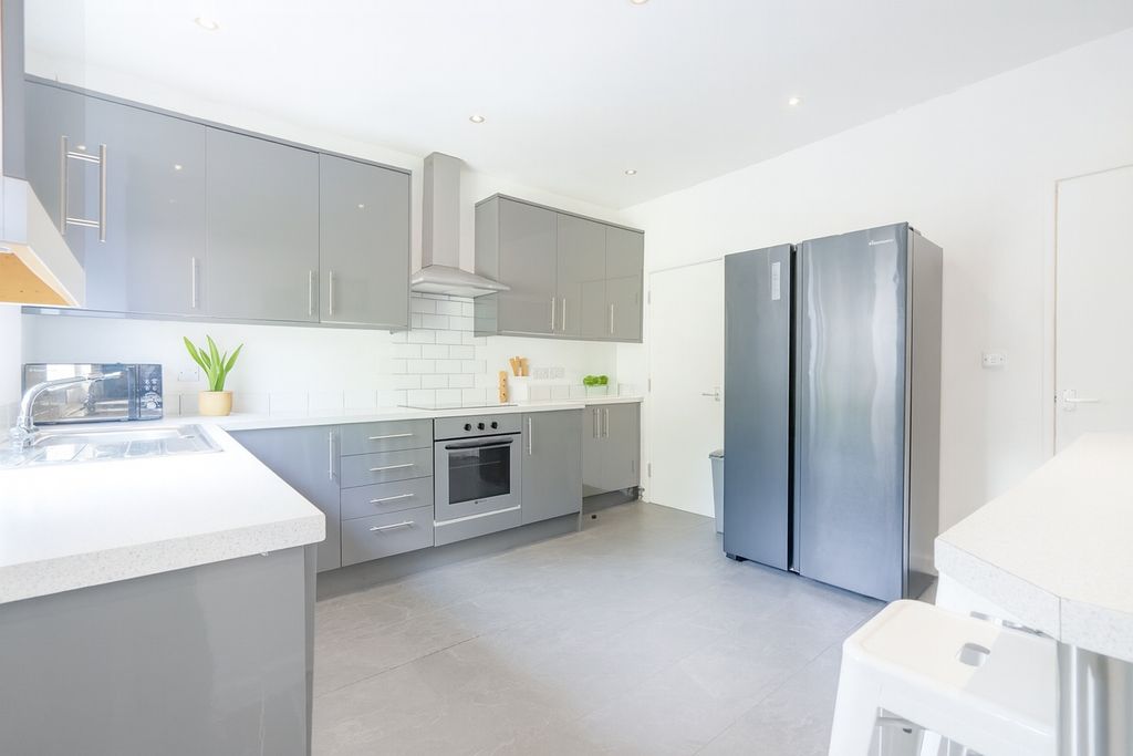 Property photo 1 of 8 Modern And Bright Kitchen Featuring Sleek Grey Cab...