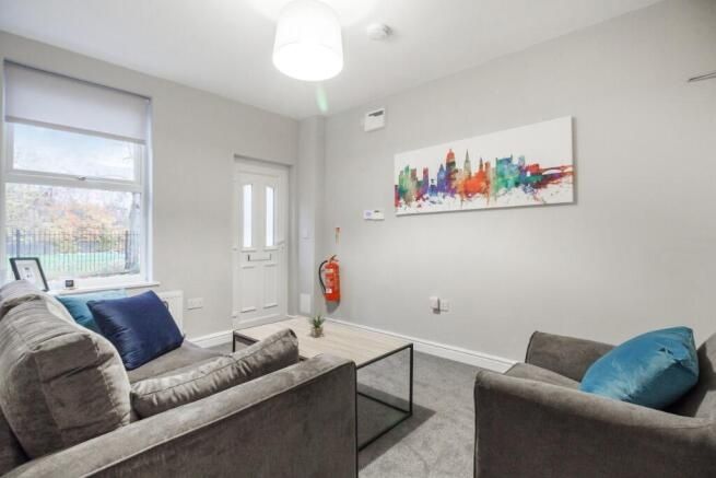 Property photo 1 of 10 A Bright And Spacious Living Room Featuring Modern...