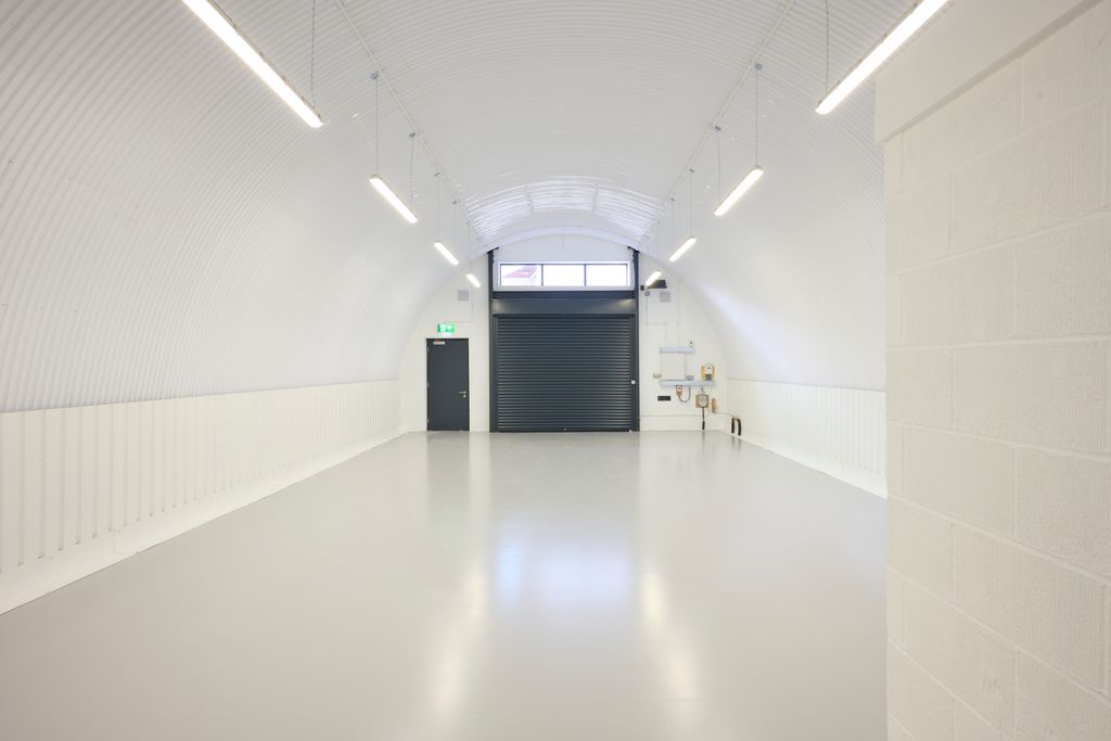 Property photo 2 of 3 The Front Of An Arch With An Open Electric Roller Shutter Entrance Big Enough For Vehicle Access, And Separate Pedestrian Door.