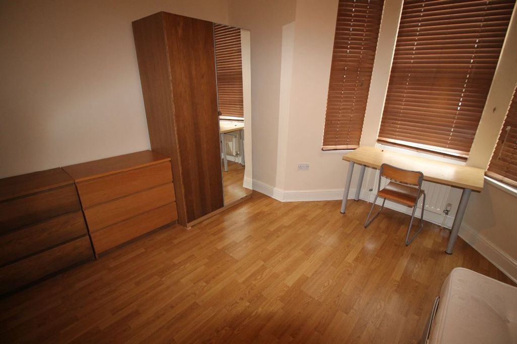 Property photo 2 of 10 A Cozy Double Bedroom Featuring Stylish Wooden Fur...