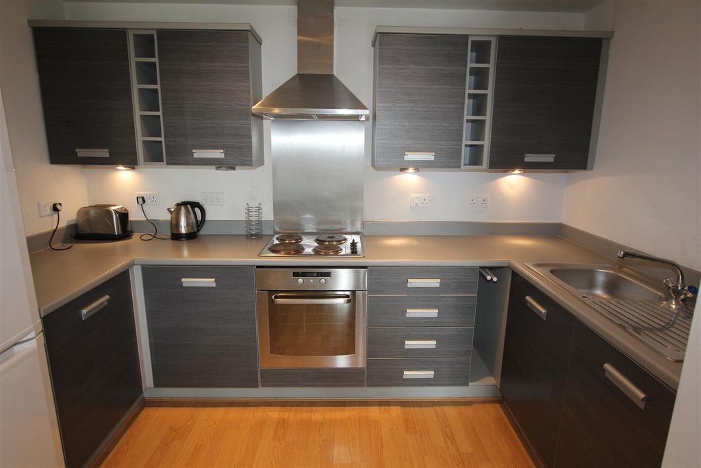 Property photo 3 of 8 Modern Kitchen With Sleek Dark Wood Cabinets...