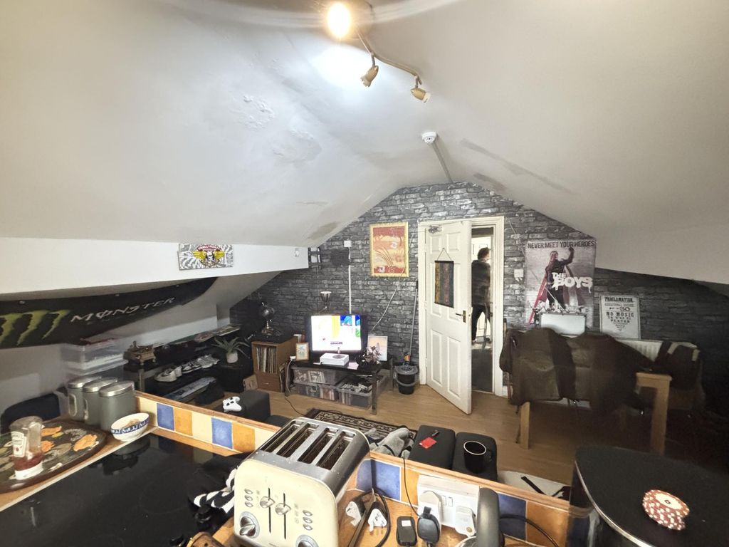 Property photo 2 of 7 A Spacious And Well-Lit Living Room With Modern Fu...