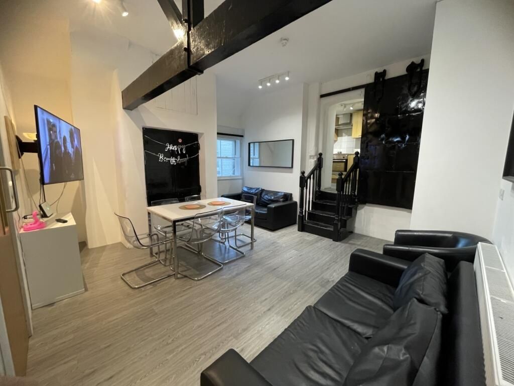 Property photo 2 of 14 A Contemporary Living Room Featuring Sleek Black l...