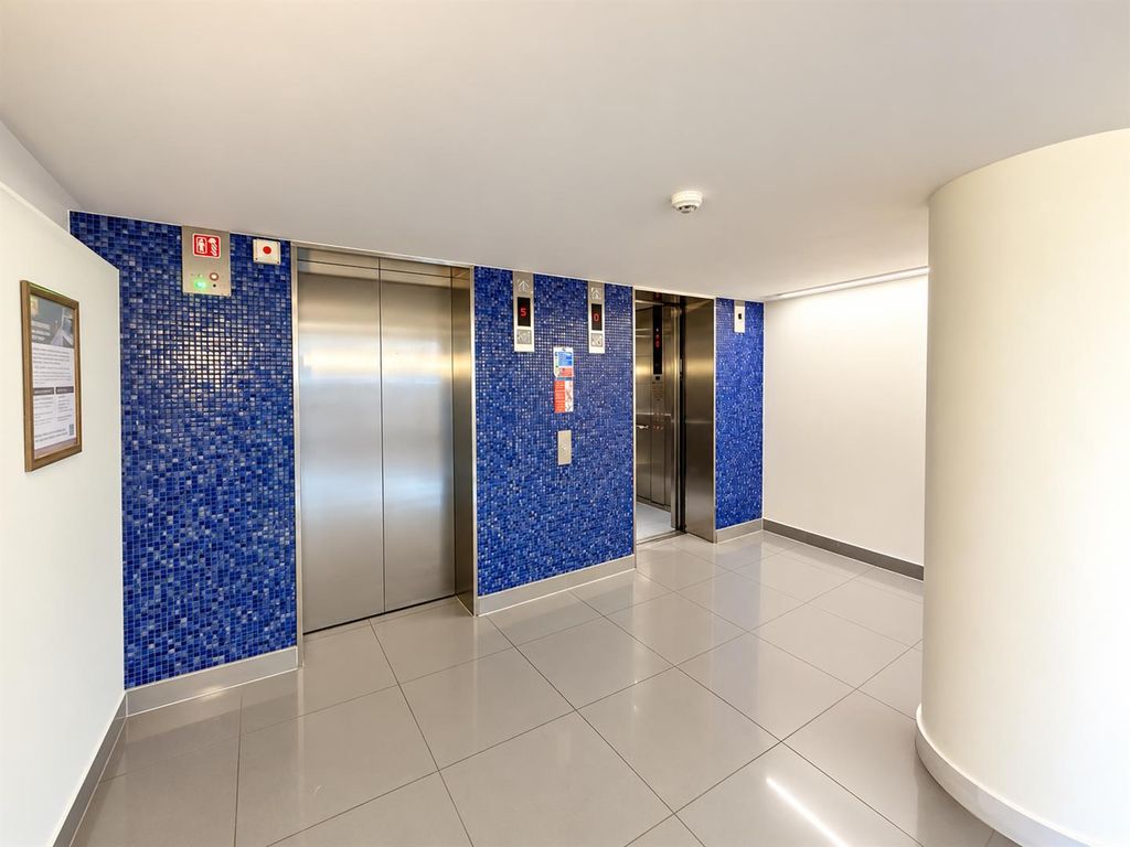Property photo 3 of 10 Pristine Blue-Tiled Elevator Lobby.Png
