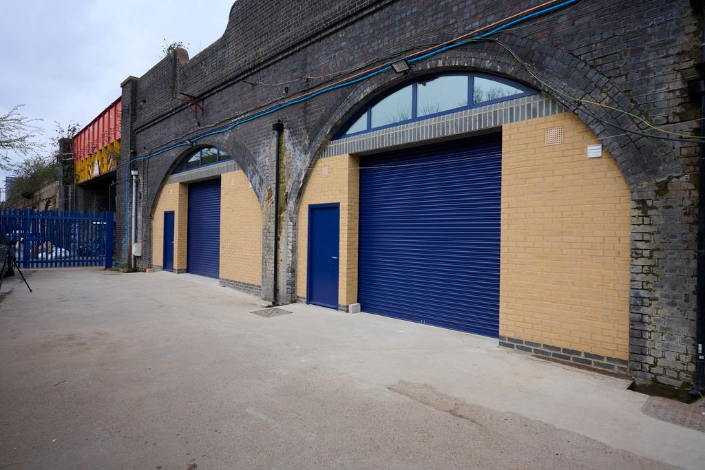 Property photo 1 of 8 The Front Of An Arch With A Closed Electric Roller Shutter Entrance Big Enough For Vehicle Access.