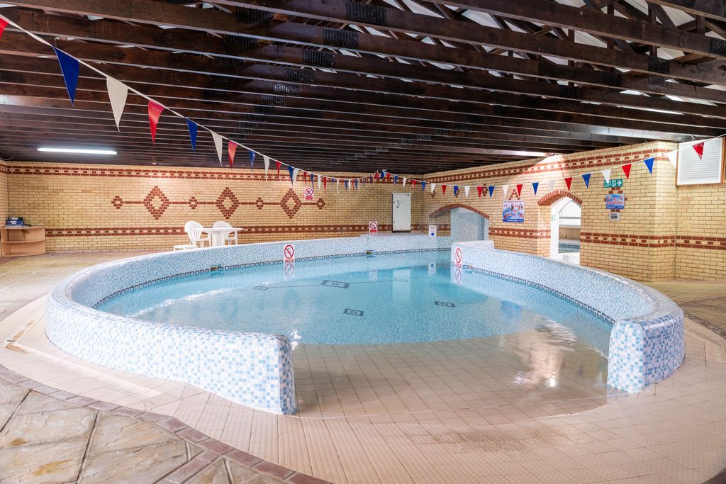 Property photo 3 of 17 Indoor Swimming Pool At Coghurst Hall Holiday Park With Seating And Bunting