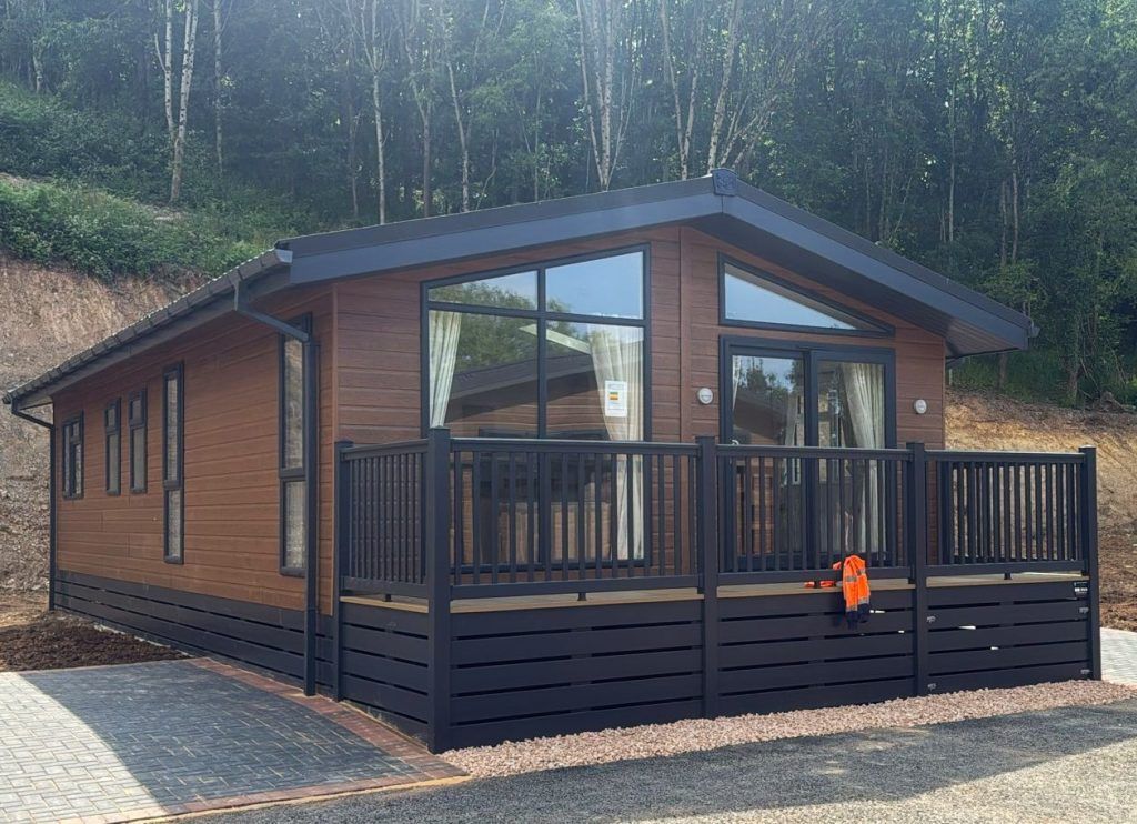 Property photo 2 of 14 Front Exterior Of The Lodge Featuring Large Windows And Enclosed Decking