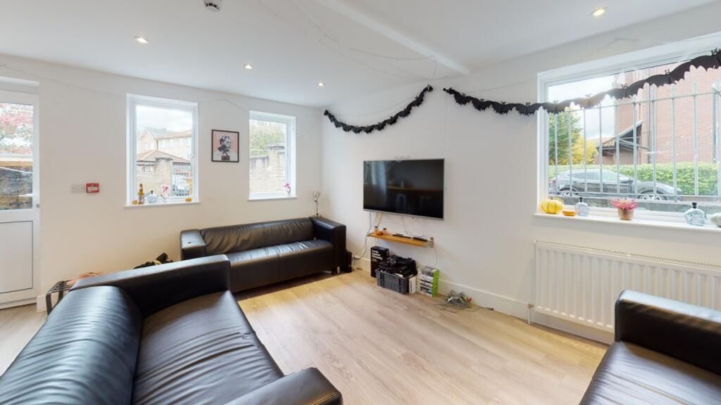 Property photo 1 of 10 Bright And Inviting Living Room Featuring Contempo...