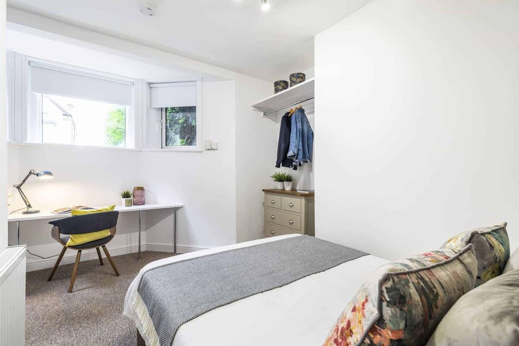 Property photo 3 of 7 A Bright And Cozy Bedroom Featuring A Comfortable ...