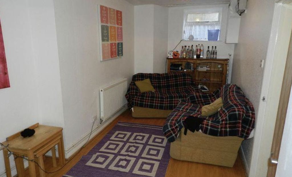 Property photo 2 of 6 A Cozy And Well-Lit Living Room Featuring A Comfor...